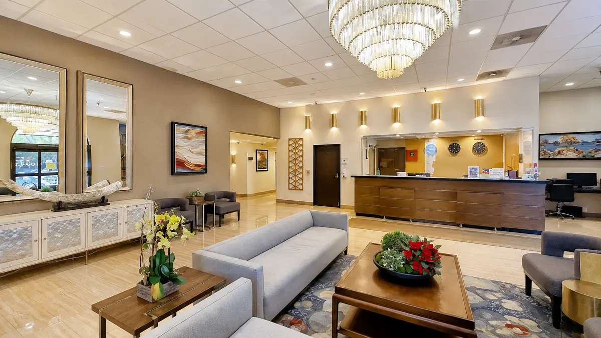Lobby reception with chandelier and front desk